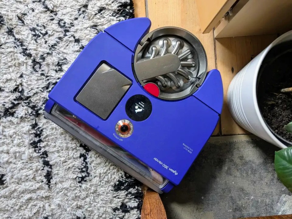 Dyson 360 Vis Nav robot vacuum cleaner on a rug.