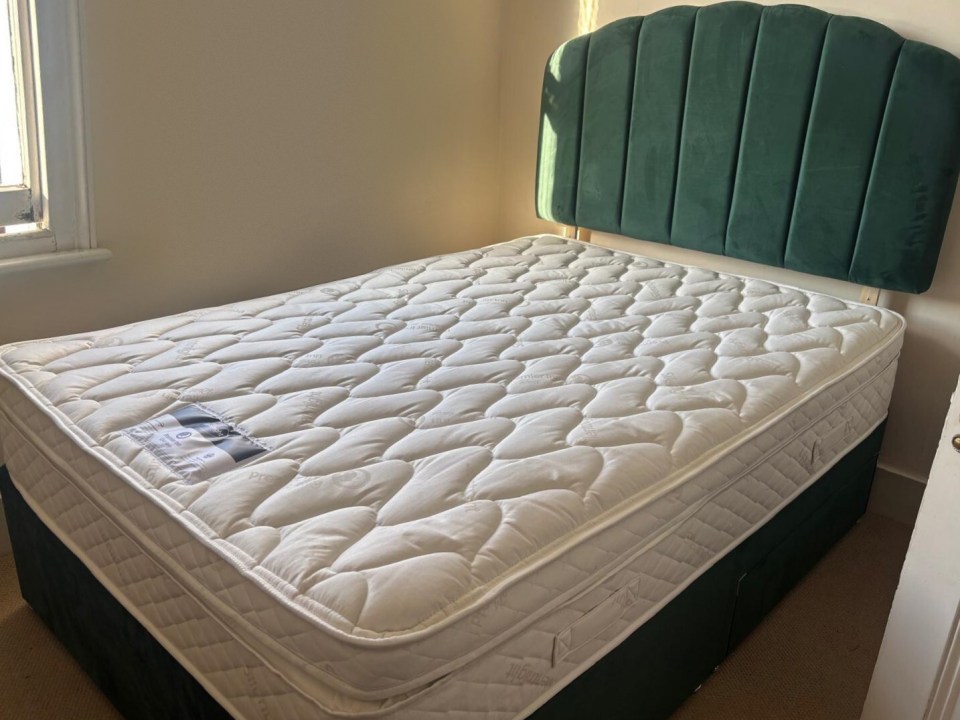 Premier Inn mattress with dark green headboard.