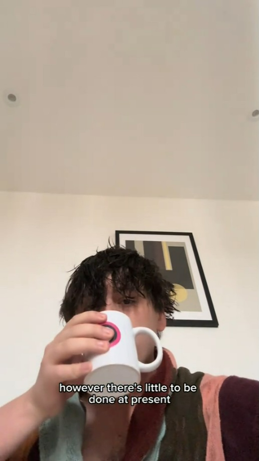 Person drinking from a mug.