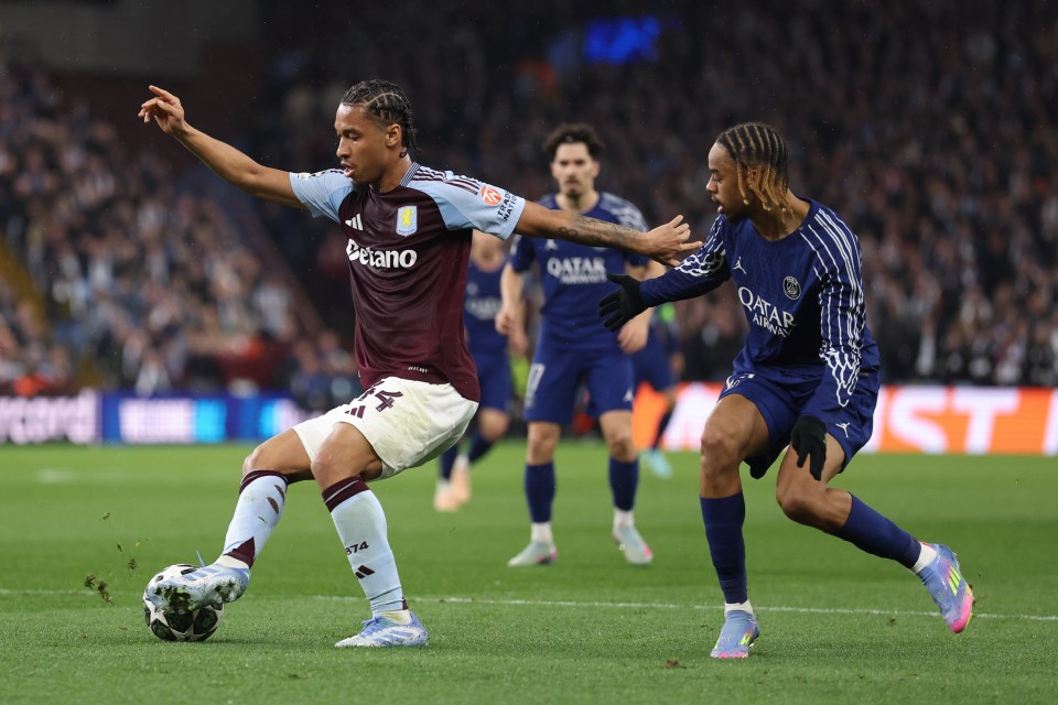 Boubacar Kamara of Aston Villa and Bradley Barcola of Paris Saint-Germain vying for the ball during a soccer match.