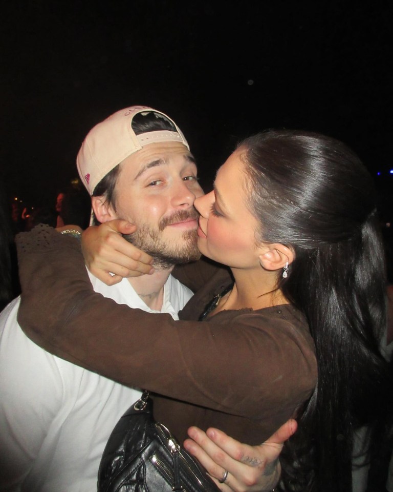 A woman kissing a man on the cheek.