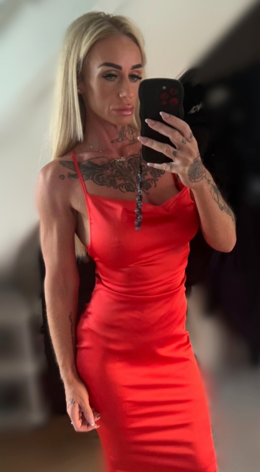 Woman in red dress taking a selfie.