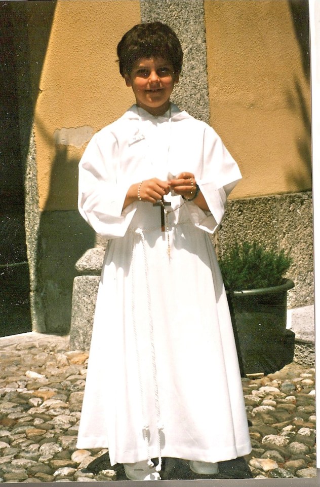 Young Carlo Acutis in First Communion attire.