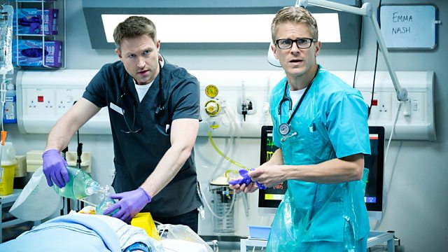 Two doctors attending to a patient in a hospital emergency room.