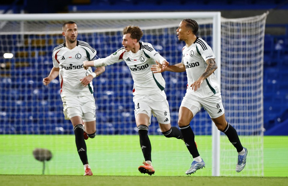 Legia Warsaw soccer players celebrating a goal.
