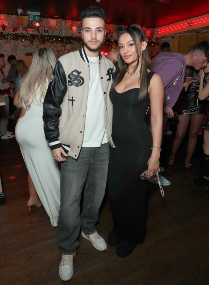 Junior Andre and a woman at a Christmas party.