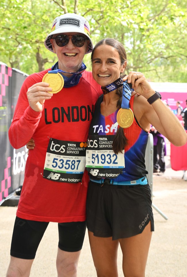 Chris Evans and Natasha Shishmanian at the London Marathon, each holding a gold medal.