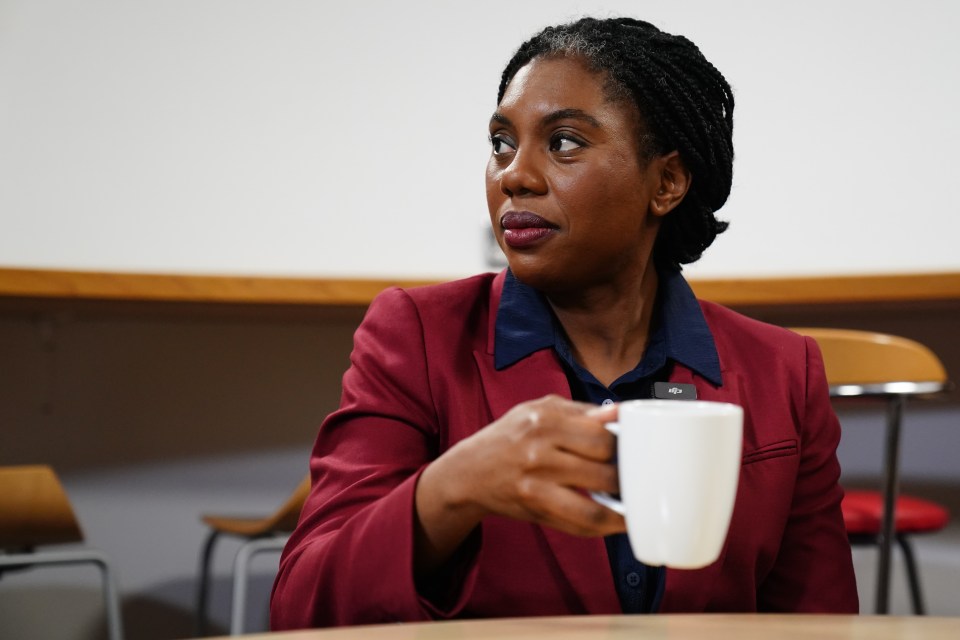 Kemi Badenoch holding a coffee cup.