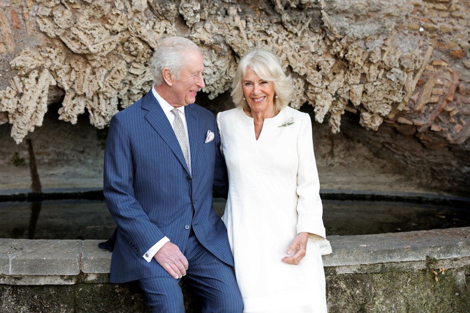 Portrait of King Charles III and Queen Camilla sitting together.