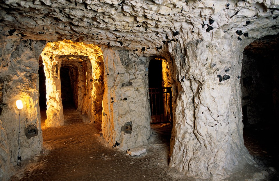 Interior of the Naours Caves, showing a network of tunnels and chambers carved into rock.