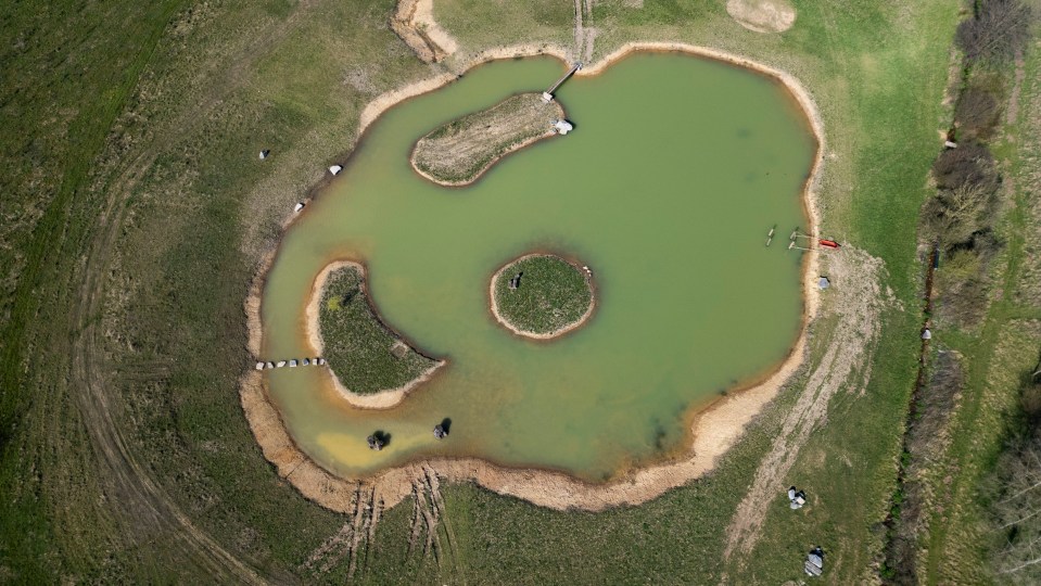 Aerial view of a man-made lake on a property.
