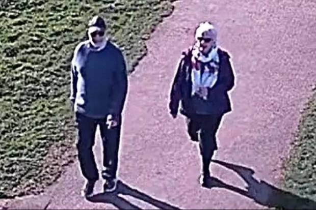 CCTV image of a man and woman walking on a path.