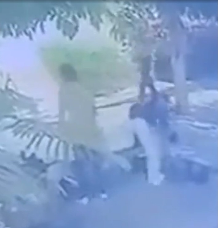Security footage of a person being apprehended.