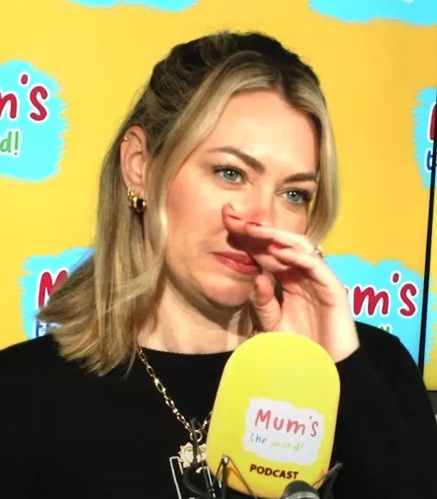 Georgia Jones wiping away tears during a podcast interview.