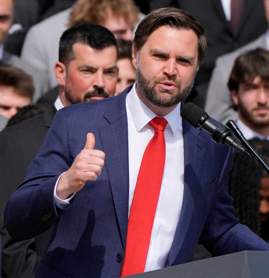 Vice President JD Vance giving a thumbs-up while speaking at an event with President Trump.
