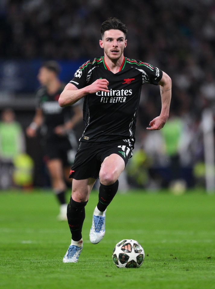 Declan Rice of Arsenal FC running with the ball during a soccer match.