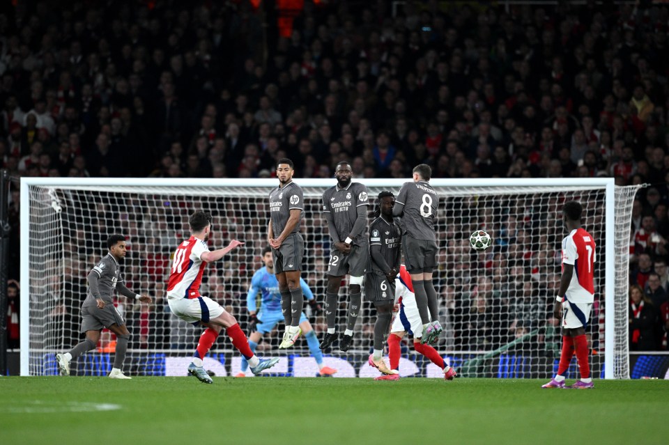 Declan Rice scoring a free kick for Arsenal against Real Madrid's defensive wall.