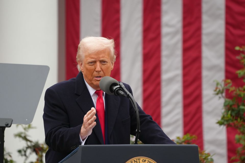 Donald Trump speaking at a podium.