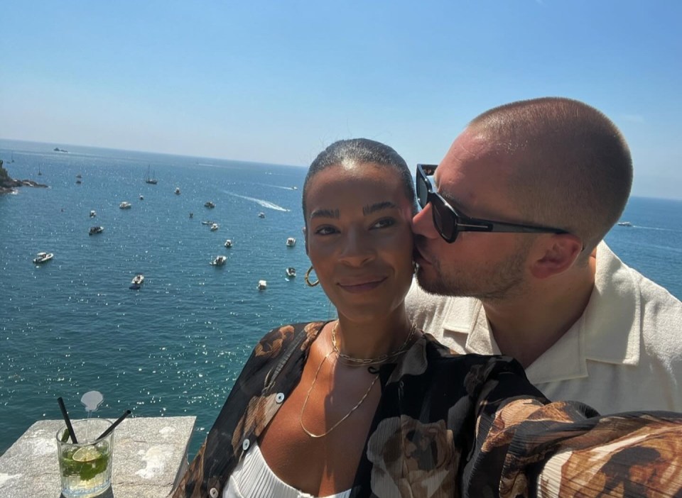 Couple embracing by the ocean.