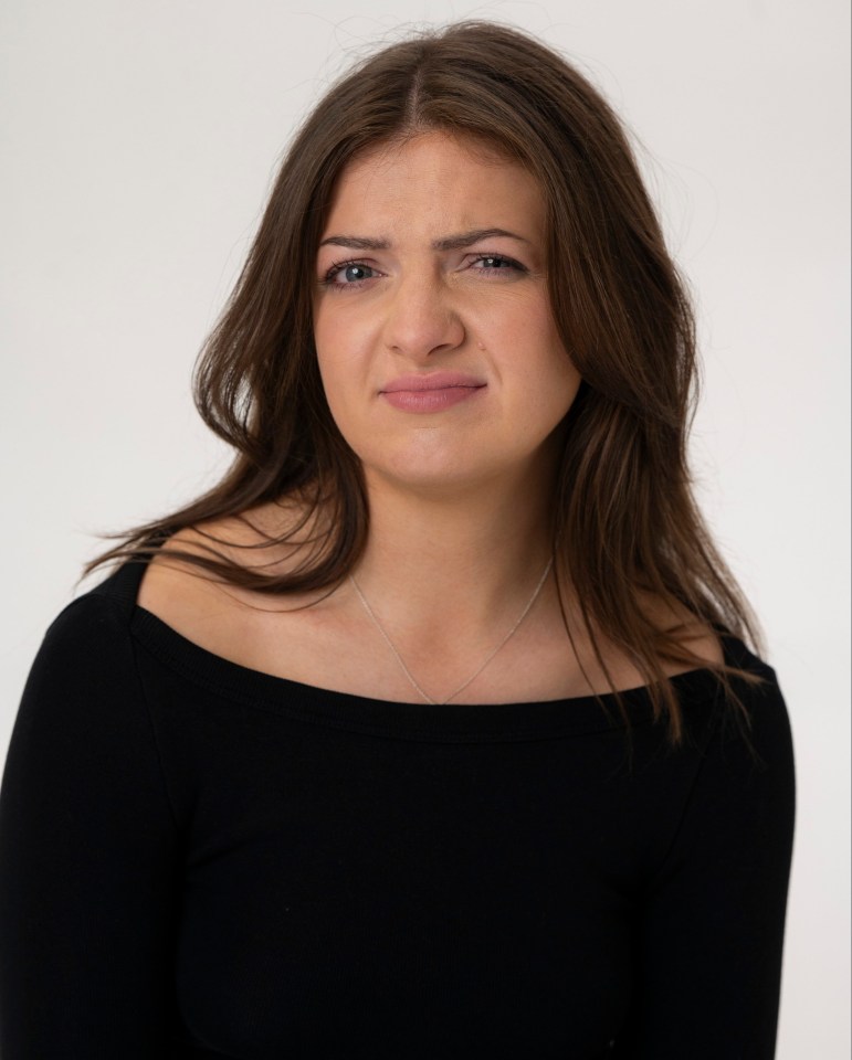 Portrait of a young woman with a skeptical expression.