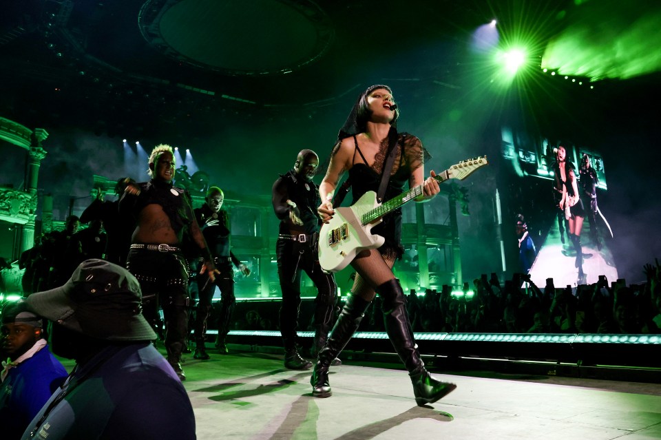 Lady Gaga performing at Coachella, playing an electric guitar.