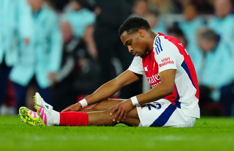 Jurrien Timber of Arsenal on the ground with a leg injury.