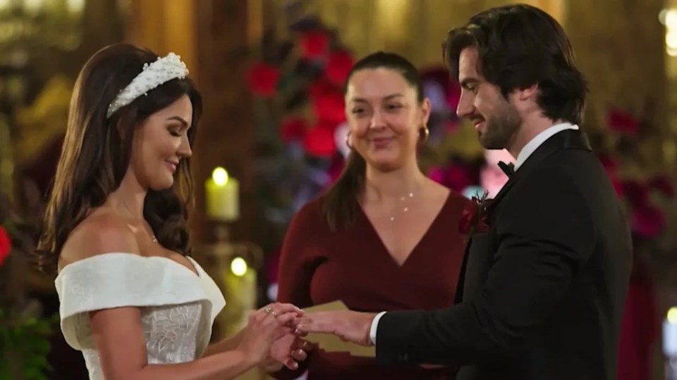 Eliot and Lauren exchanging rings at their wedding.