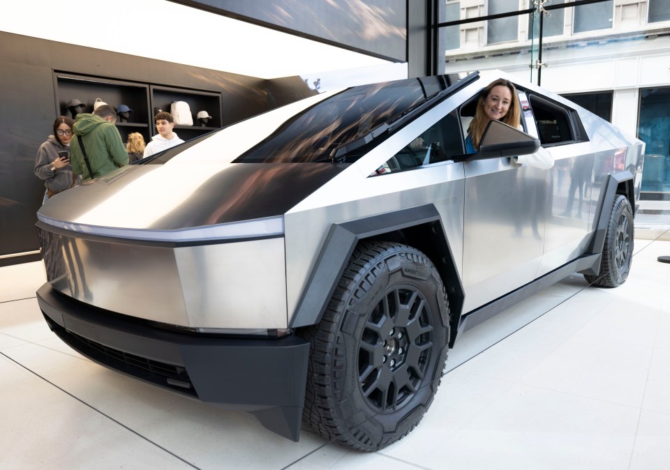 Woman smiling in a Tesla Cybertruck.