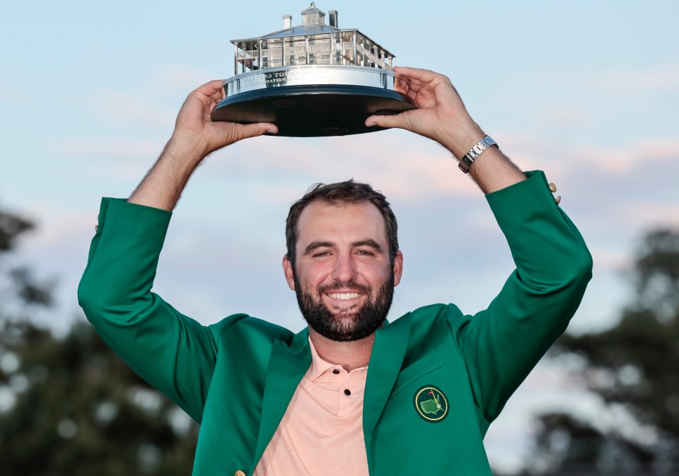 Scottie Scheffler holding the Masters Tournament trophy.