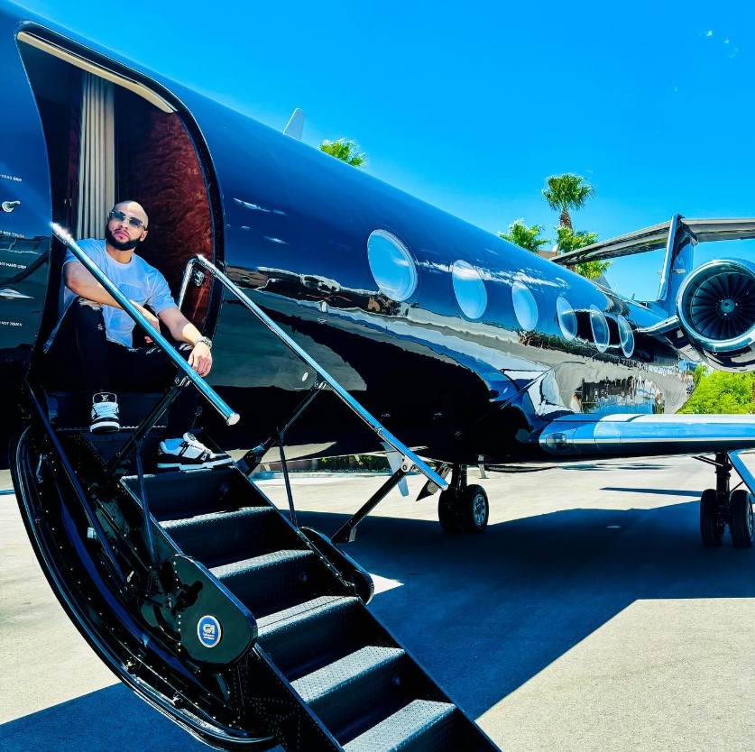 Chris Eubank Jr. sitting on the steps of a private jet.