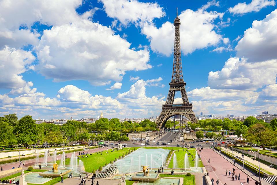 The Eiffel Tower in Paris, France, viewed from across a park with fountains.