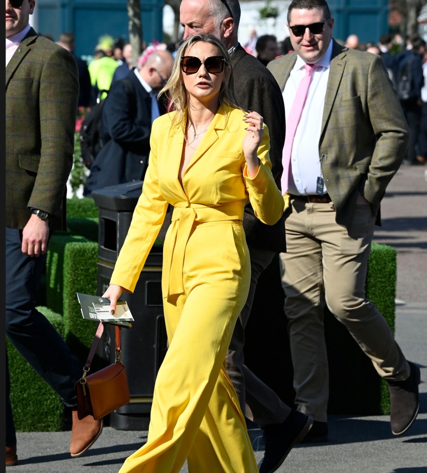 Woman in yellow jumpsuit at Aintree Grand National Festival.