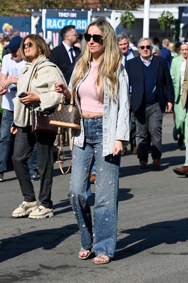 Woman in pearl-embellished jeans at the Aintree Grand National Festival.
