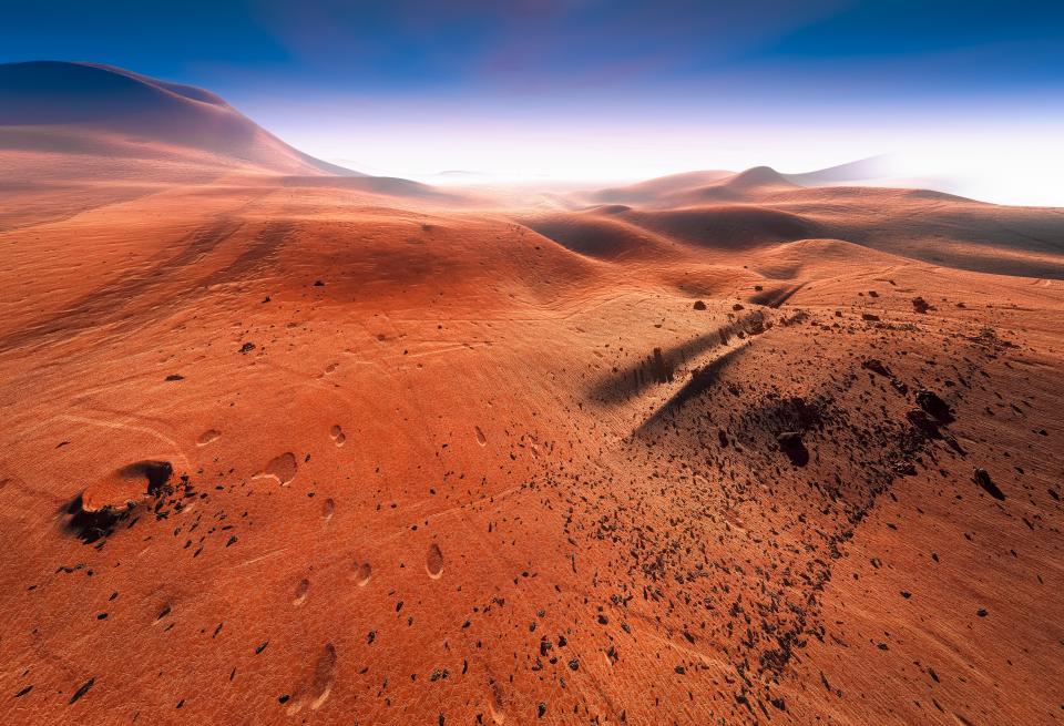 Illustration of footprints on the red surface of Mars.