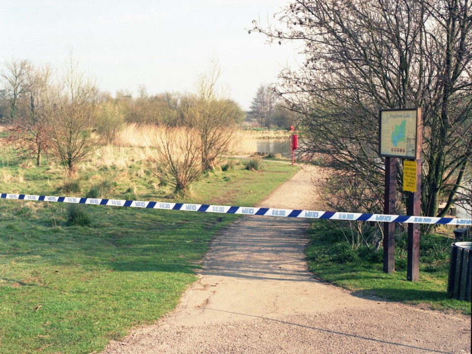 Police tape across a path at a crime scene.