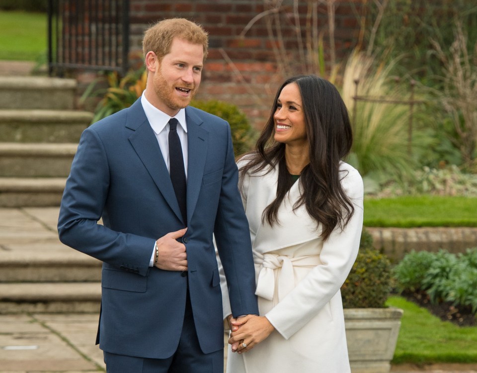 Prince Harry and Meghan Markle holding hands in Kensington Palace gardens.