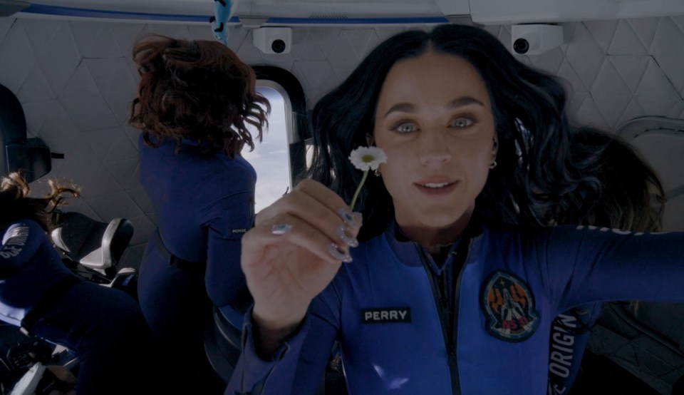 Katy Perry holds a daisy while experiencing zero gravity on a Blue Origin space flight.