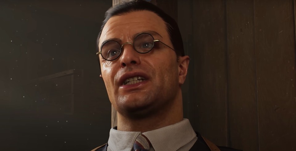 Close-up of a man wearing glasses and a collared shirt.