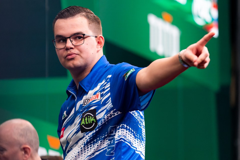 Gian van Veen of the Netherlands reacting during a darts match.