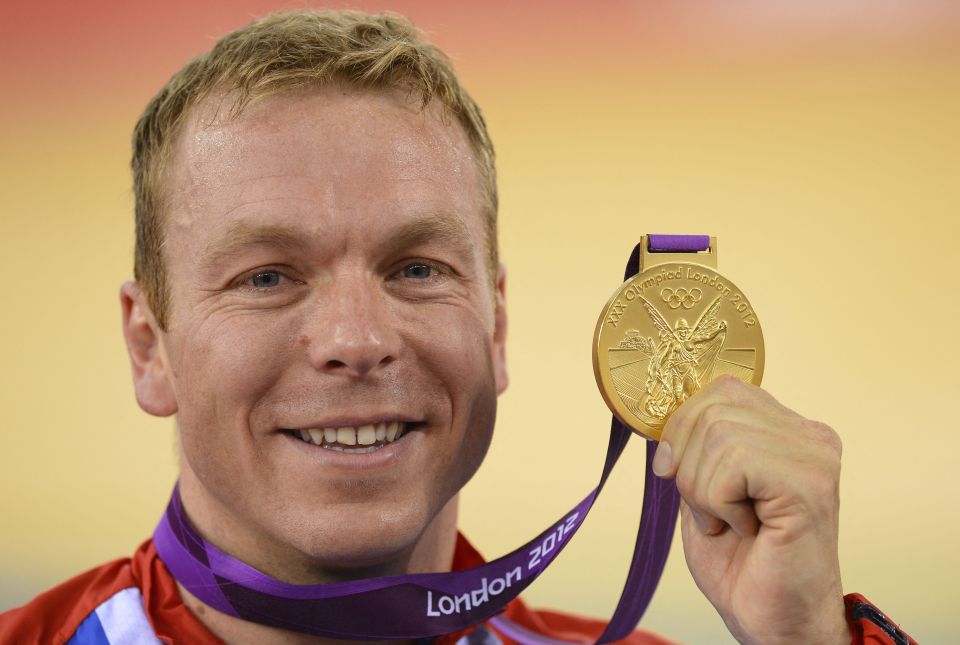 Chris Hoy holding his gold medal from the 2012 London Olympics.