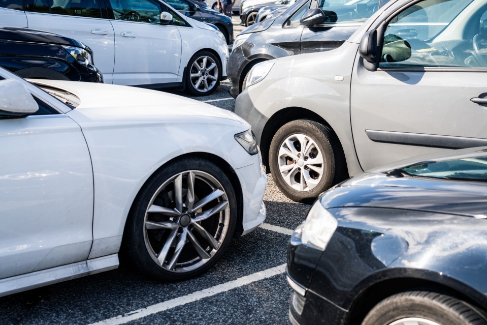 Cars parked in a row in a parking lot.