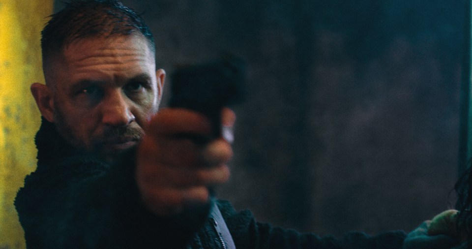Tom Hardy as Walker in Havoc, aiming a gun.