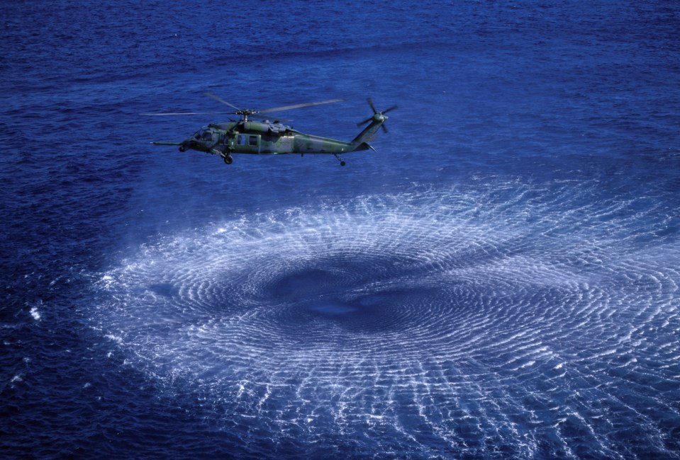 Helicopter performing sea rescue exercises.