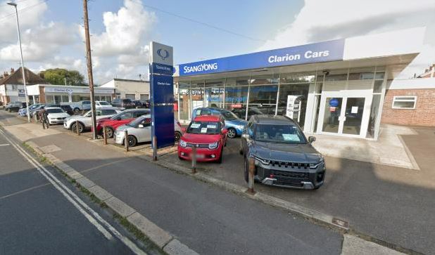 Clarion Cars dealership with cars parked in front.