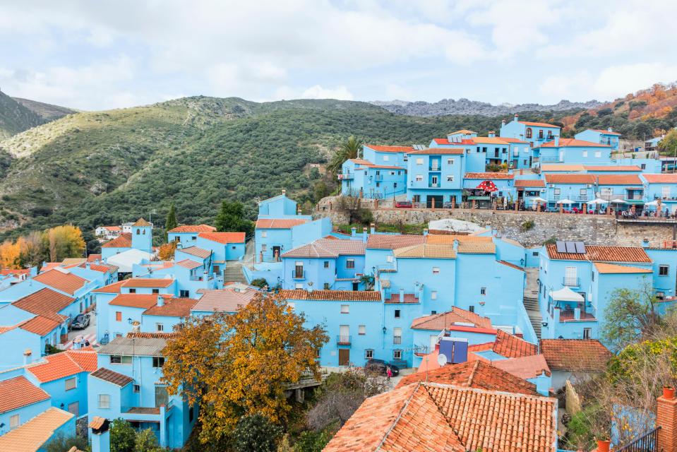 Aerial view of Juzcar, Spain, a village with blue buildings.