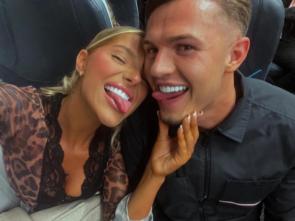 Selfie of a couple sticking their tongues out.
