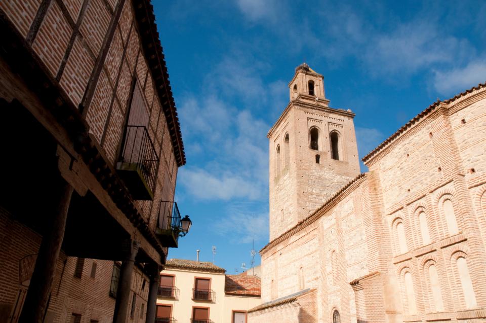 Brick buildings and church tower in Arevalo, Spain.