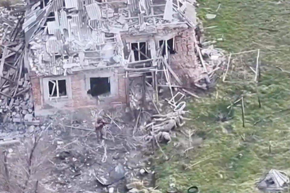 Drone footage of a destroyed building and surrendering soldiers.
