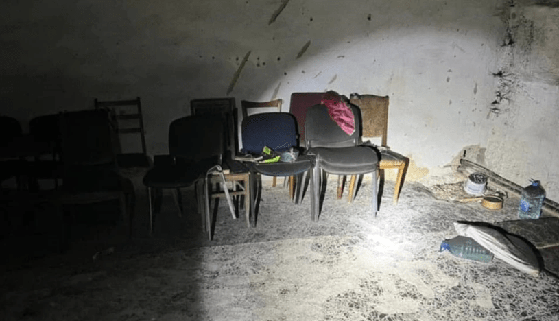 Chairs and debris in a damaged room.