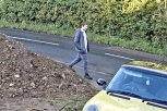 Person walking near a yellow car.